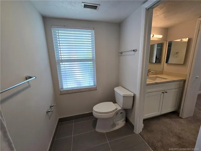 a bathroom with a toilet sink and a mirror