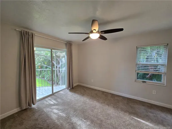a view of a livingroom with a ceiling fan and window