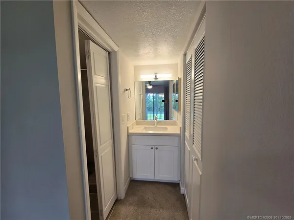 a white toilet sitting in a bathroom next to a sink