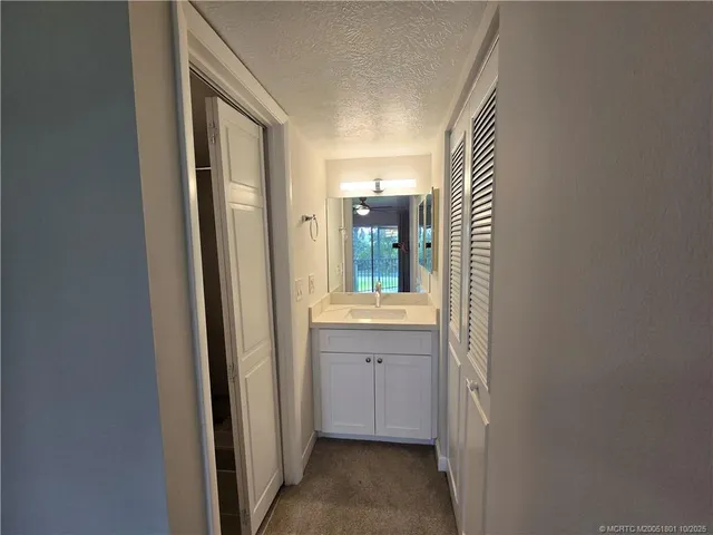 a white toilet sitting in a bathroom next to a sink