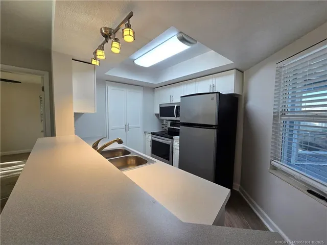 a bedroom with a bed and a refrigerator