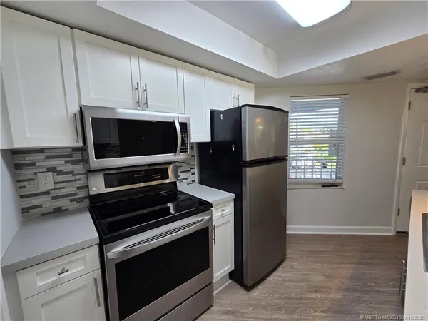 a kitchen with appliances and cabinets