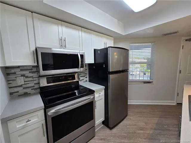 a kitchen with appliances and cabinets