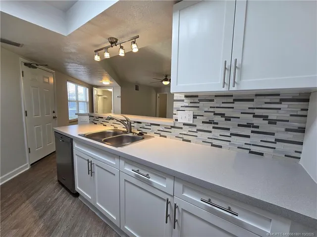 a kitchen with a sink and cabinets