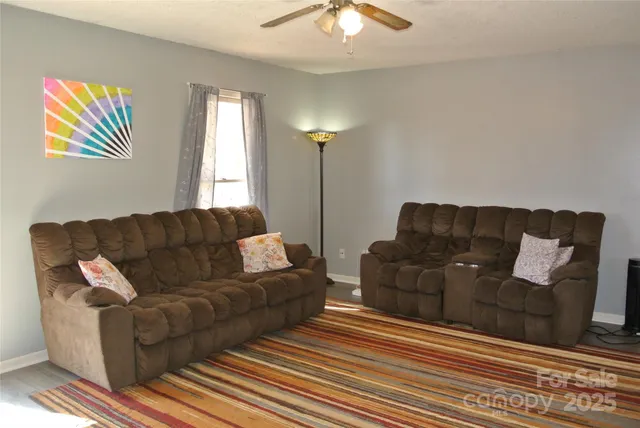 a living room with furniture and a lamp