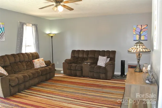 a living room with furniture and a chandelier