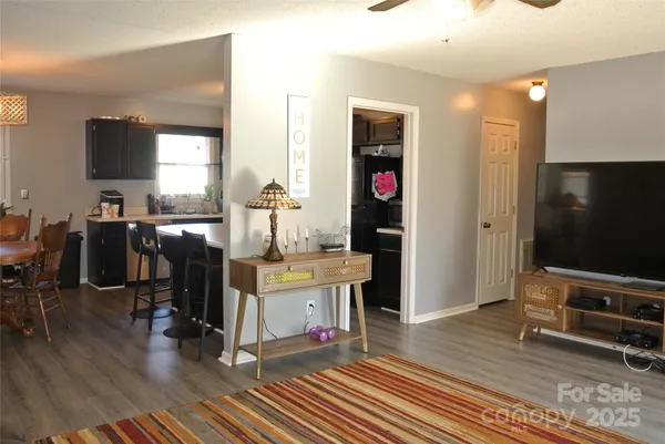 a view of a livingroom with furniture and a flat screen tv
