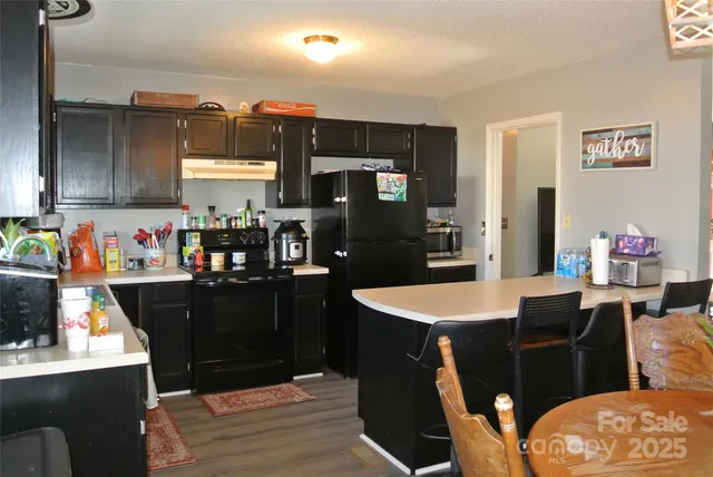a kitchen with a table and chairs