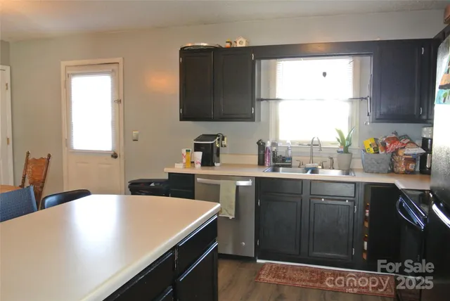 a kitchen with a sink cabinets and window