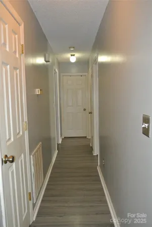 a view of a hallway with wooden floor