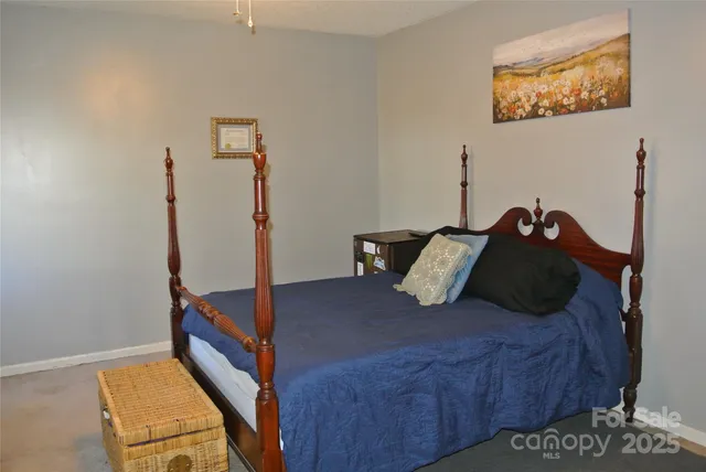 a bed sitting in a bedroom next to a window