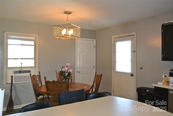 a view of a dining room with furniture and chandelier