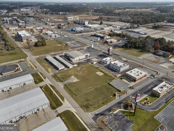 an aerial view of a residential houses with city view