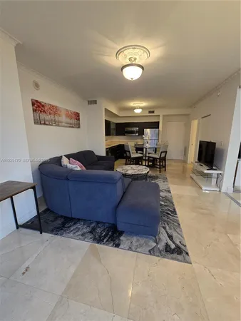 a kitchen with a table chairs and a refrigerator