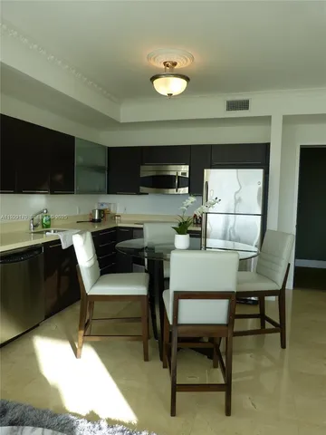 a kitchen with sink stove and cabinets