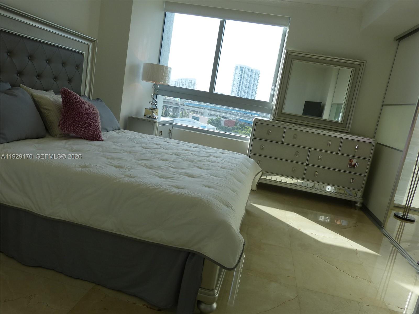 90 Southwest 3rd Street, Unit 1110 Miami, FL 33130 - Photo 19 of 55 a bedroom with a bed and window