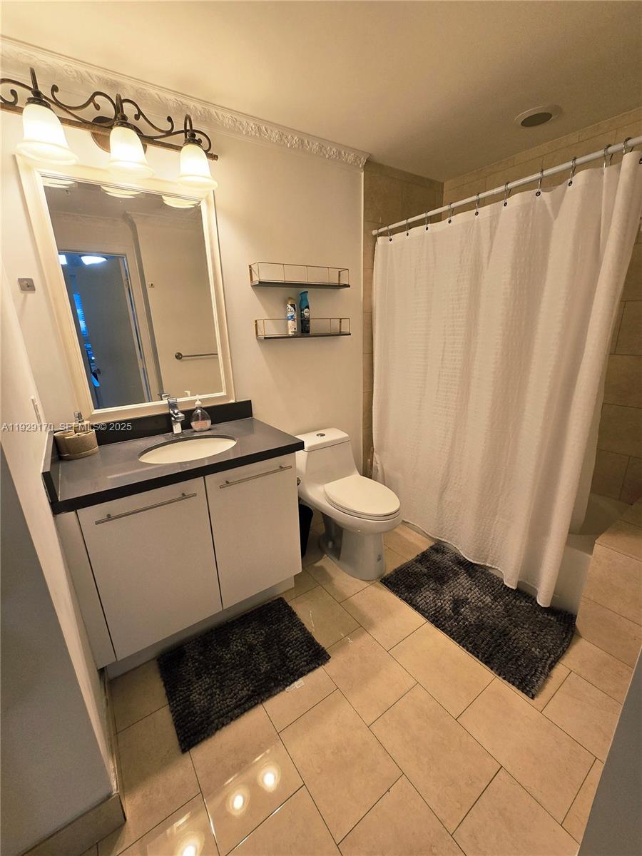 90 Southwest 3rd Street, Unit 1110 Miami, FL 33130 - Photo 26 of 55 a bathroom with a sink a toilet a mirror and shower