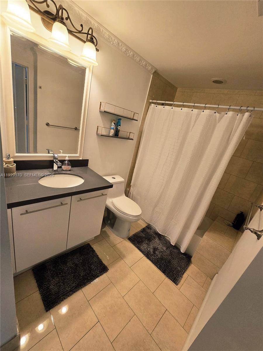 90 Southwest 3rd Street, Unit 1110 Miami, FL 33130 - Photo 27 of 55 a bathroom with a sink a toilet a mirror and shower