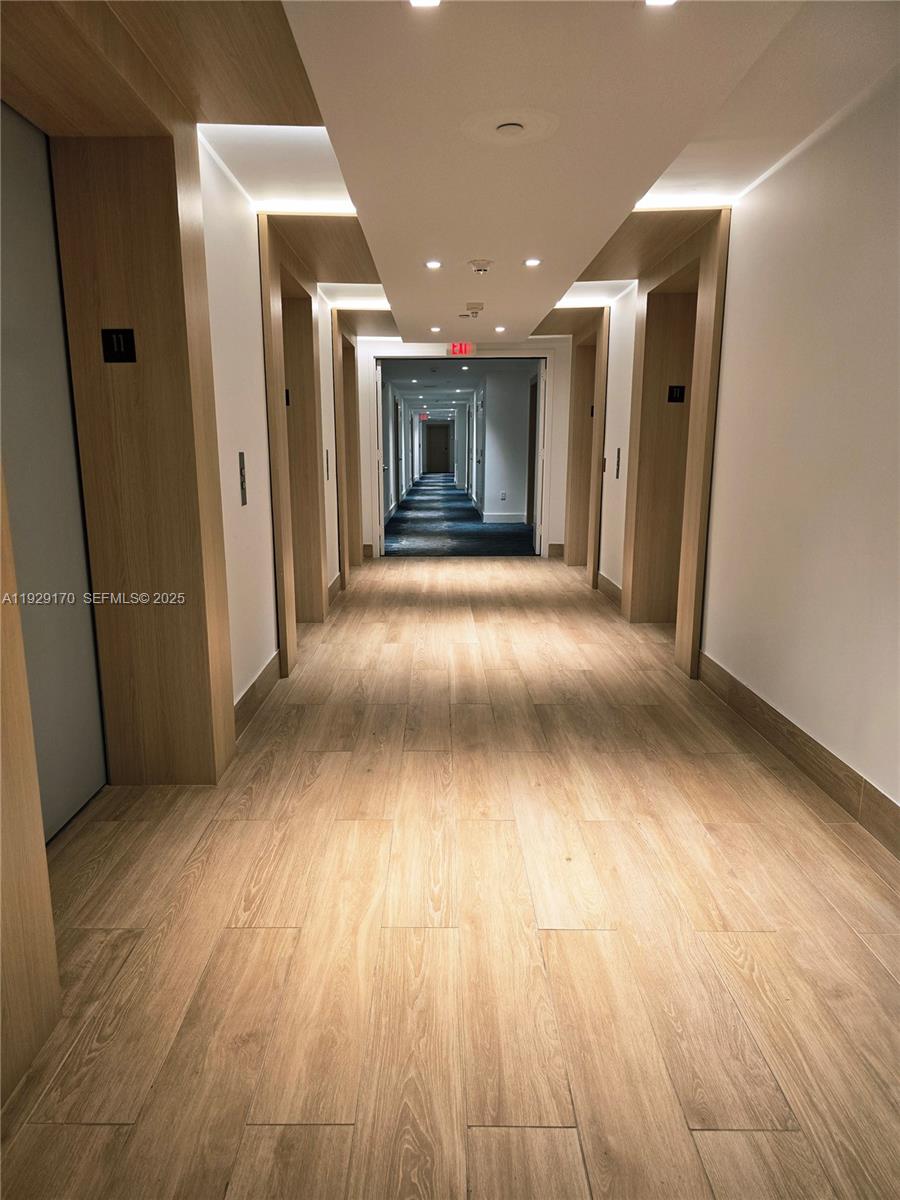 90 Southwest 3rd Street, Unit 1110 Miami, FL 33130 - Photo 29 of 55 an empty room with wooden floor and natural light