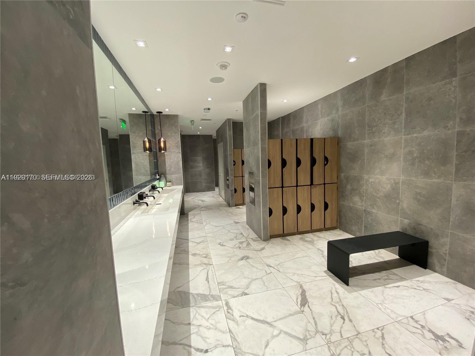 90 Southwest 3rd Street, Unit 1110 Miami, FL 33130 - Photo 38 of 55 a bathroom with a tub sink and mirror