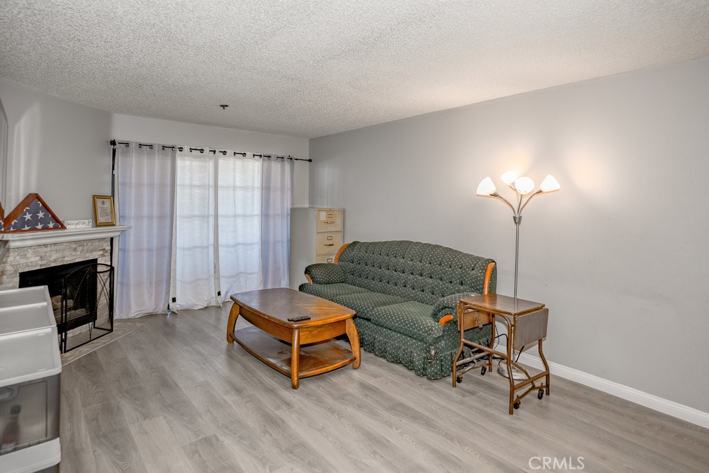 6545 Reseda Boulevard, Unit 3 Reseda, CA 91335 - Photo 3 of 12 a living room with furniture and a fireplace