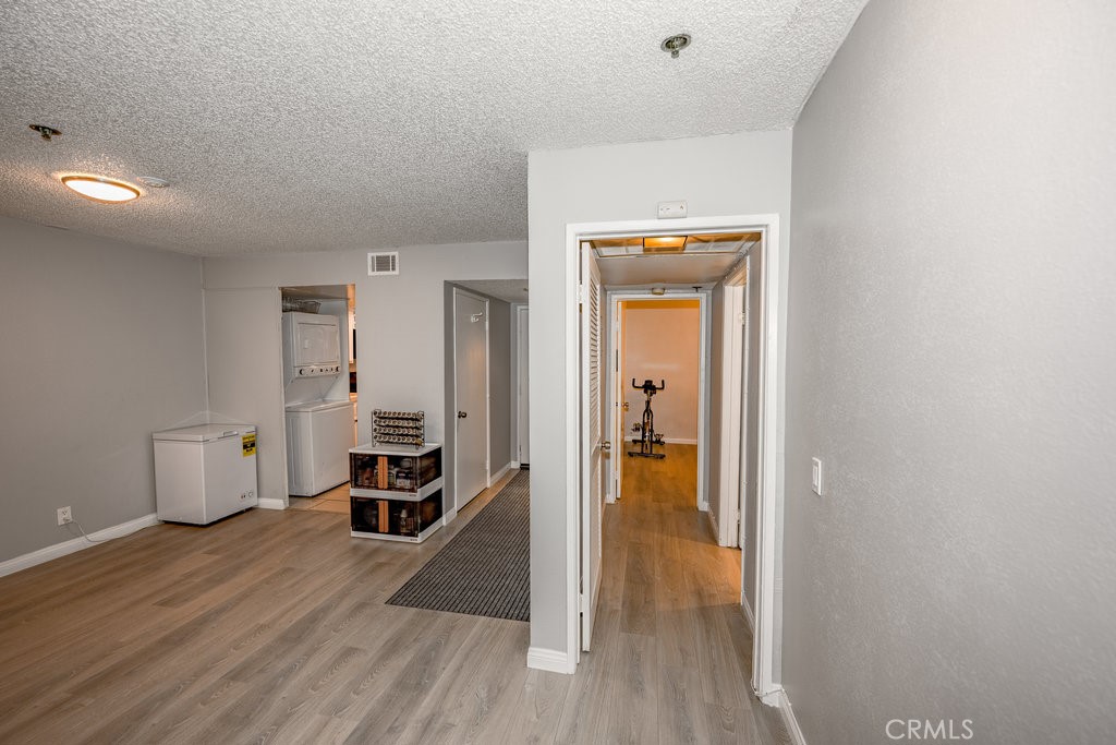 6545 Reseda Boulevard, Unit 3 Reseda, CA 91335 - Photo 4 of 12 a view of a hallway and wooden floor a livingroom with windows