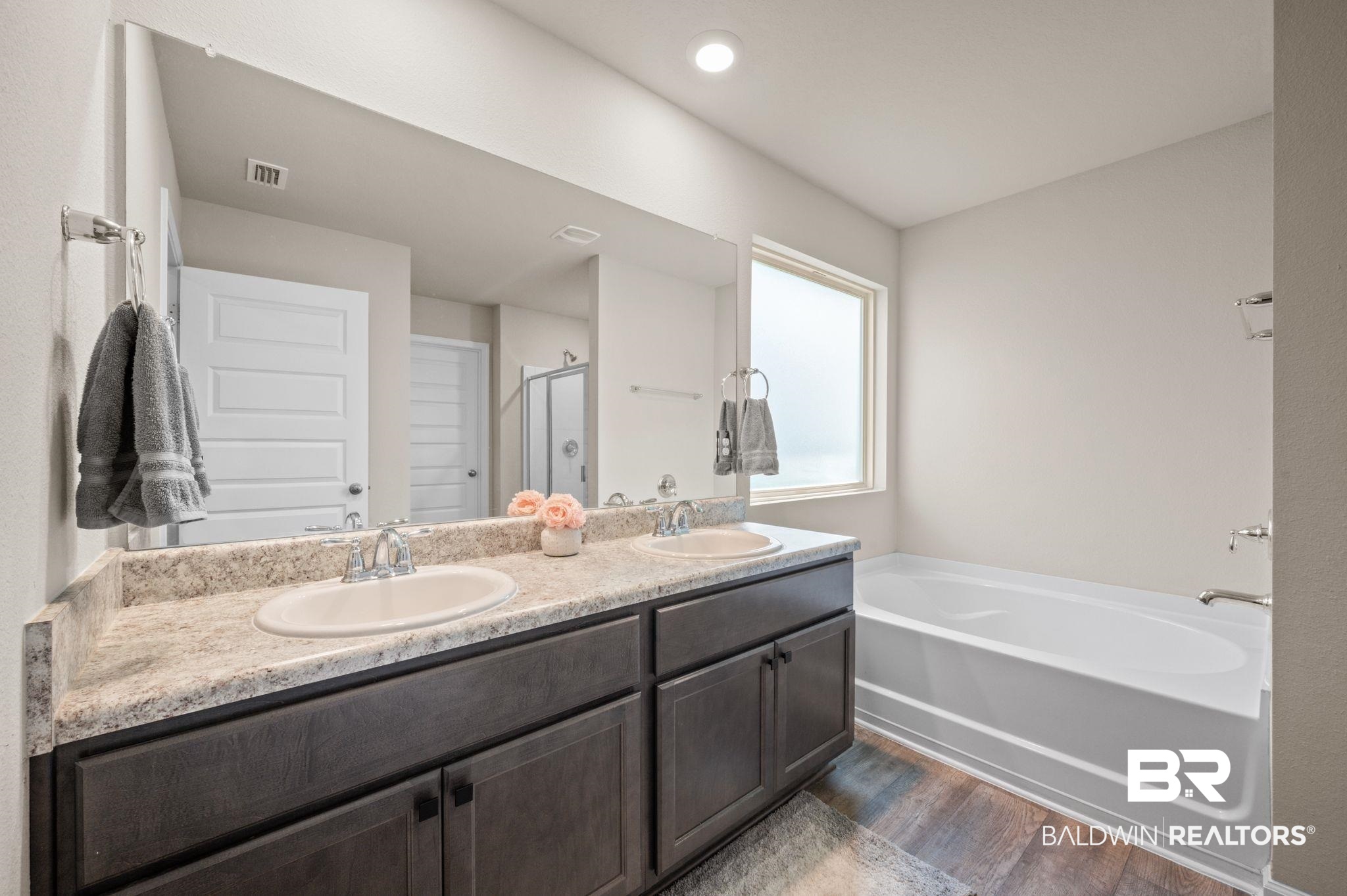 10306 Brodick Loop Spanish Fort, AL 36527 - Photo 18 of 35 Bathroom with hardwood / wood-style flooring, vanity, and plus walk in shower
