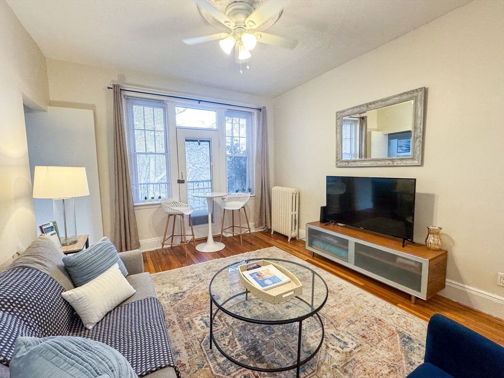 29 Mt Hood Road, Unit 12FURNISHED Boston, MA 02135 - Photo 1 of 11 a living room with furniture and a flat screen tv