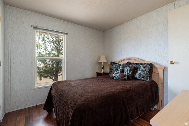 740 Riddle Drive Fredonia, AZ 86022 - Photo 12 of 20 Bedroom featuring wood-finish flooring, a single window with blinds, and light-toned walls