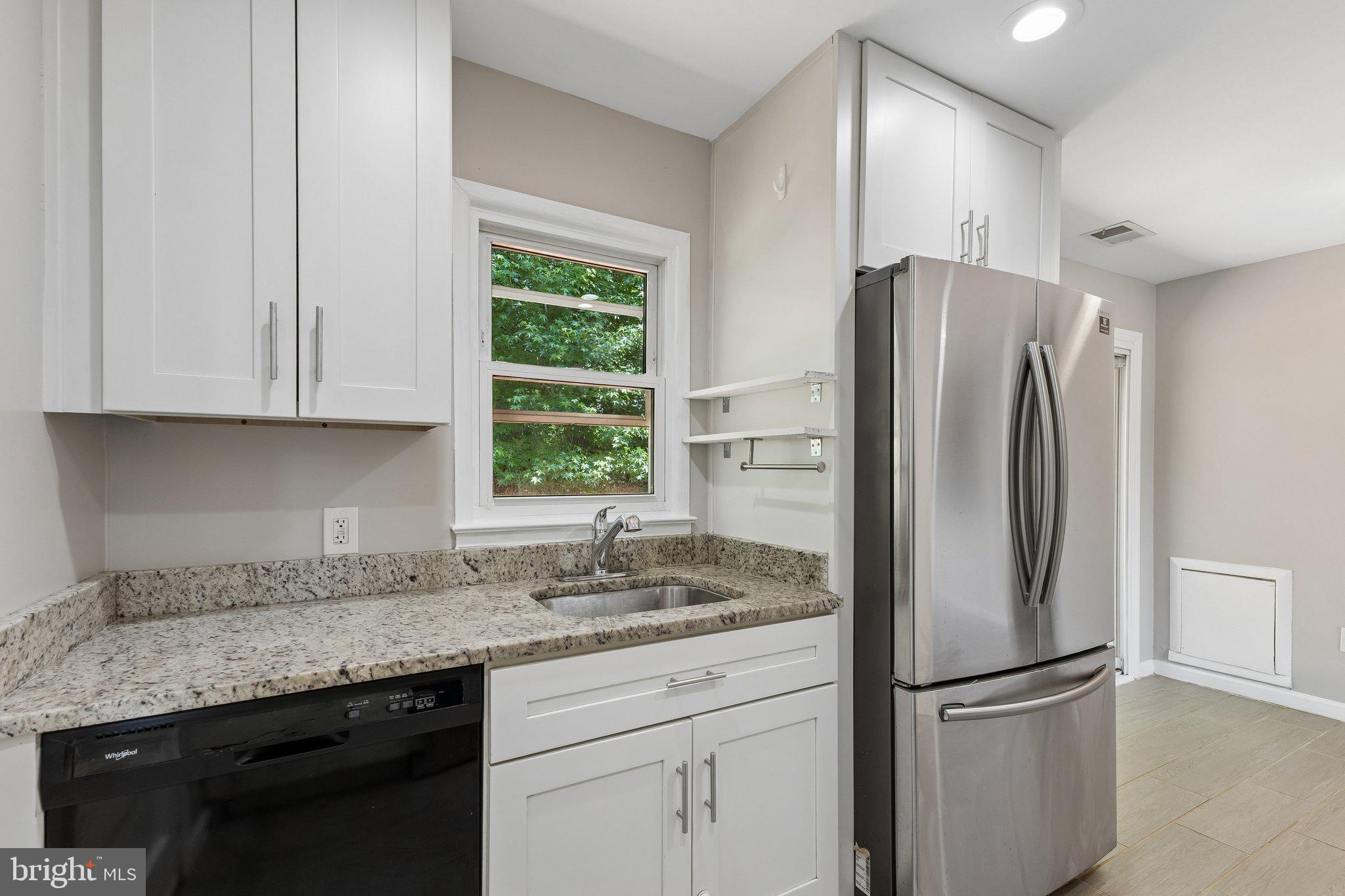 14197 Fullerton Road Woodbridge, VA 22193 - Photo 5 of 23 a kitchen with stainless steel appliances granite countertop a refrigerator and a sink