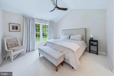 a spacious bedroom with a bed and a couch