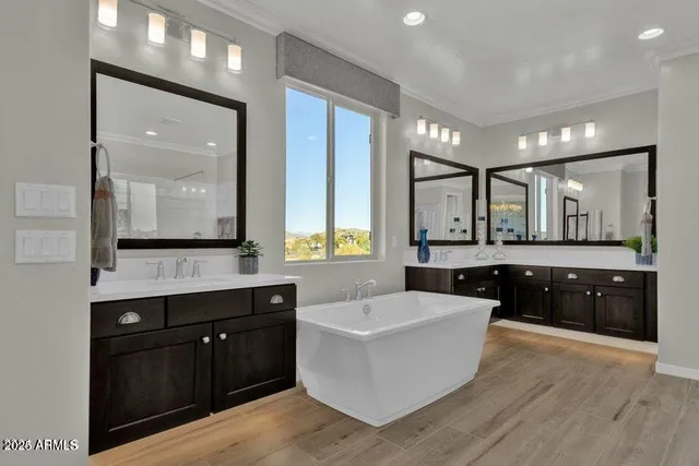 a large bathroom with a large tub and sink