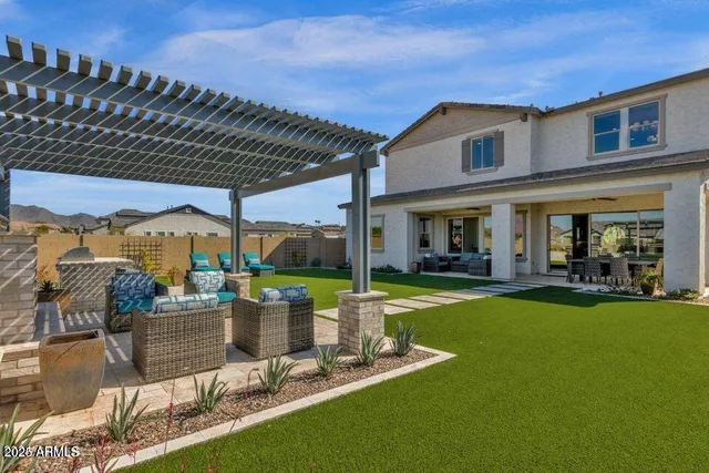 a view of a house with backyard porch and sitting area