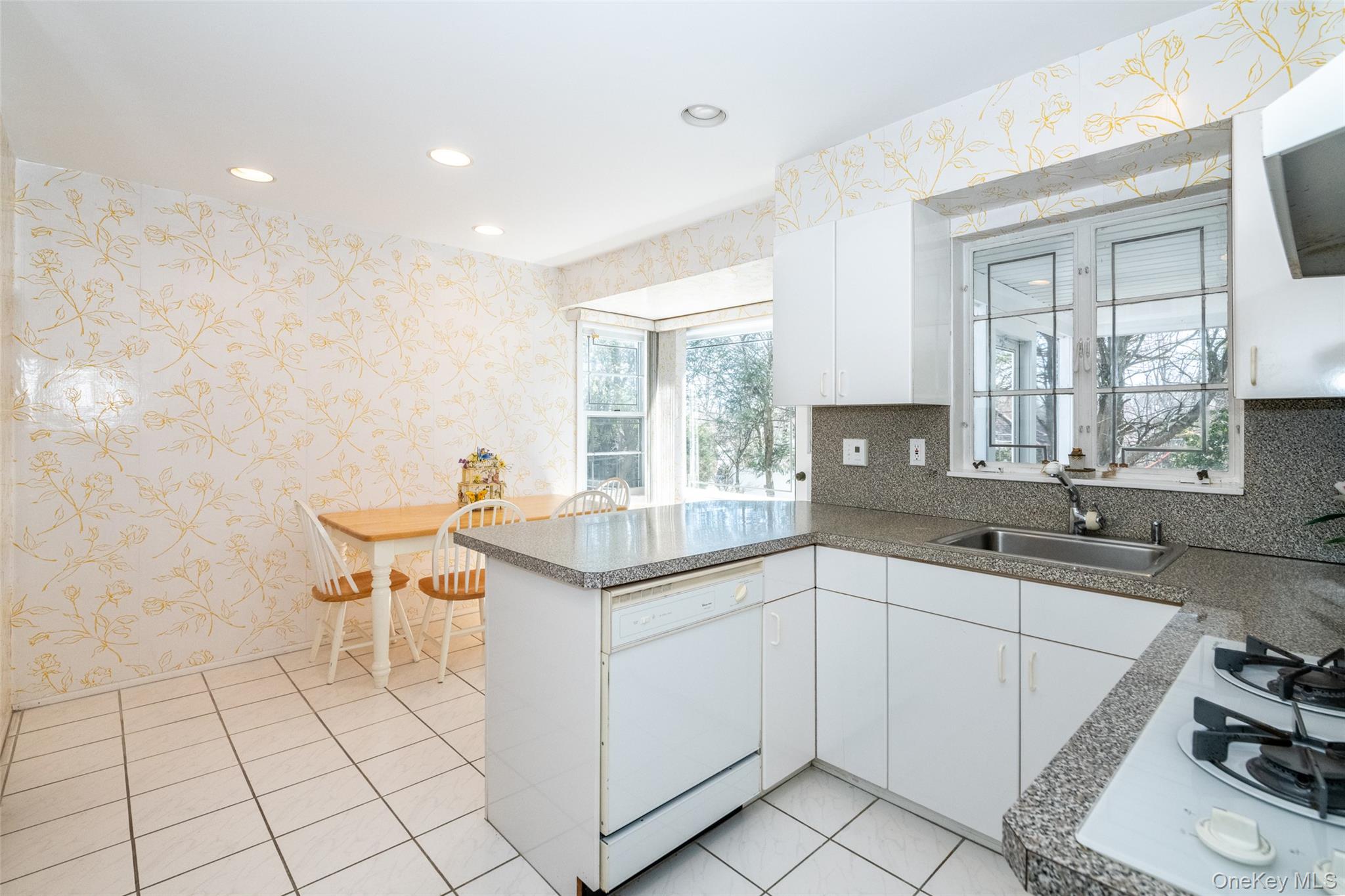 285 Stuart Drive New Rochelle, NY 10804 - Photo 11 of 37 a kitchen with a sink and chairs