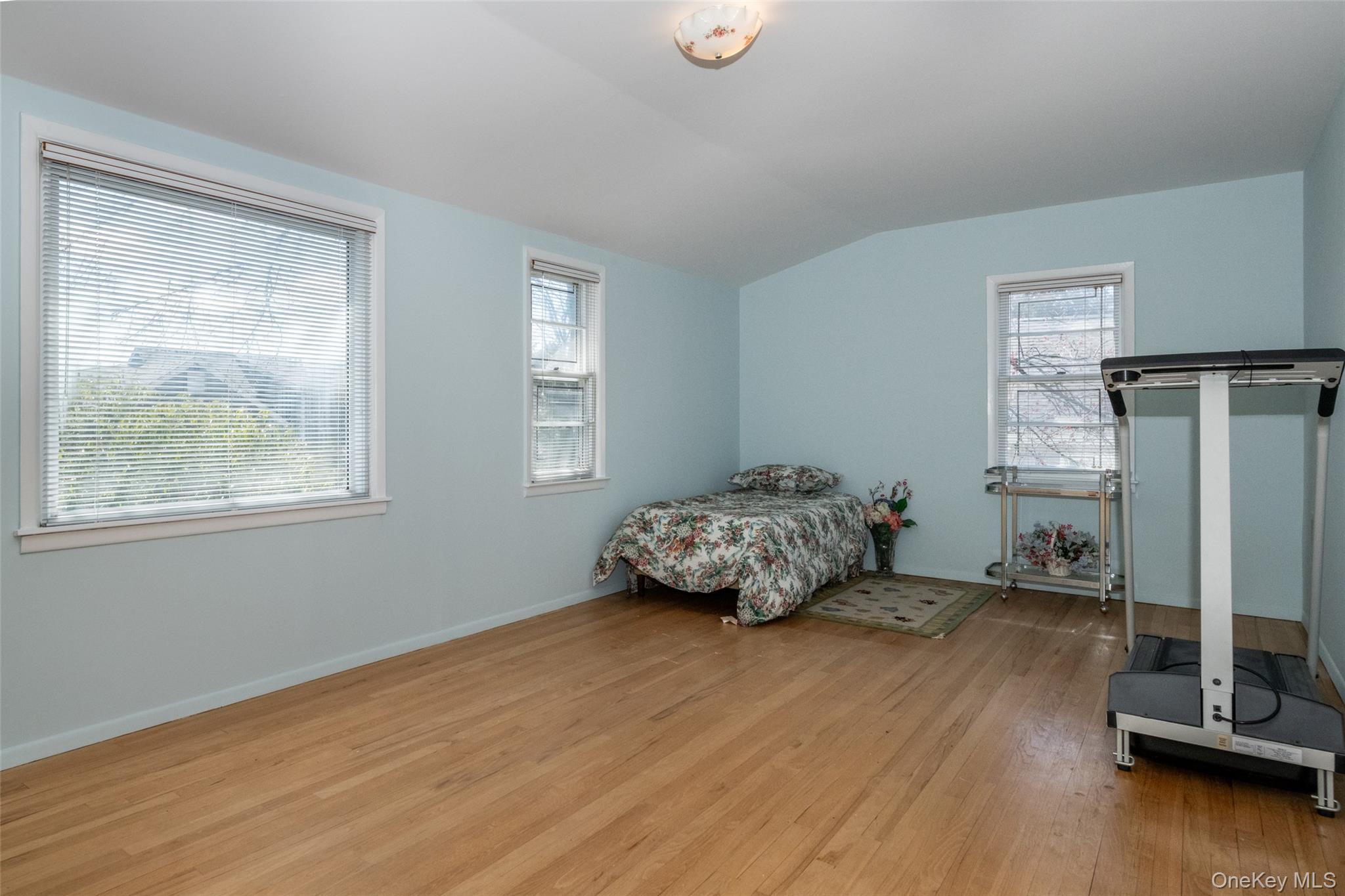 285 Stuart Drive New Rochelle, NY 10804 - Photo 21 of 37 a bedroom with a bed and wooden floor