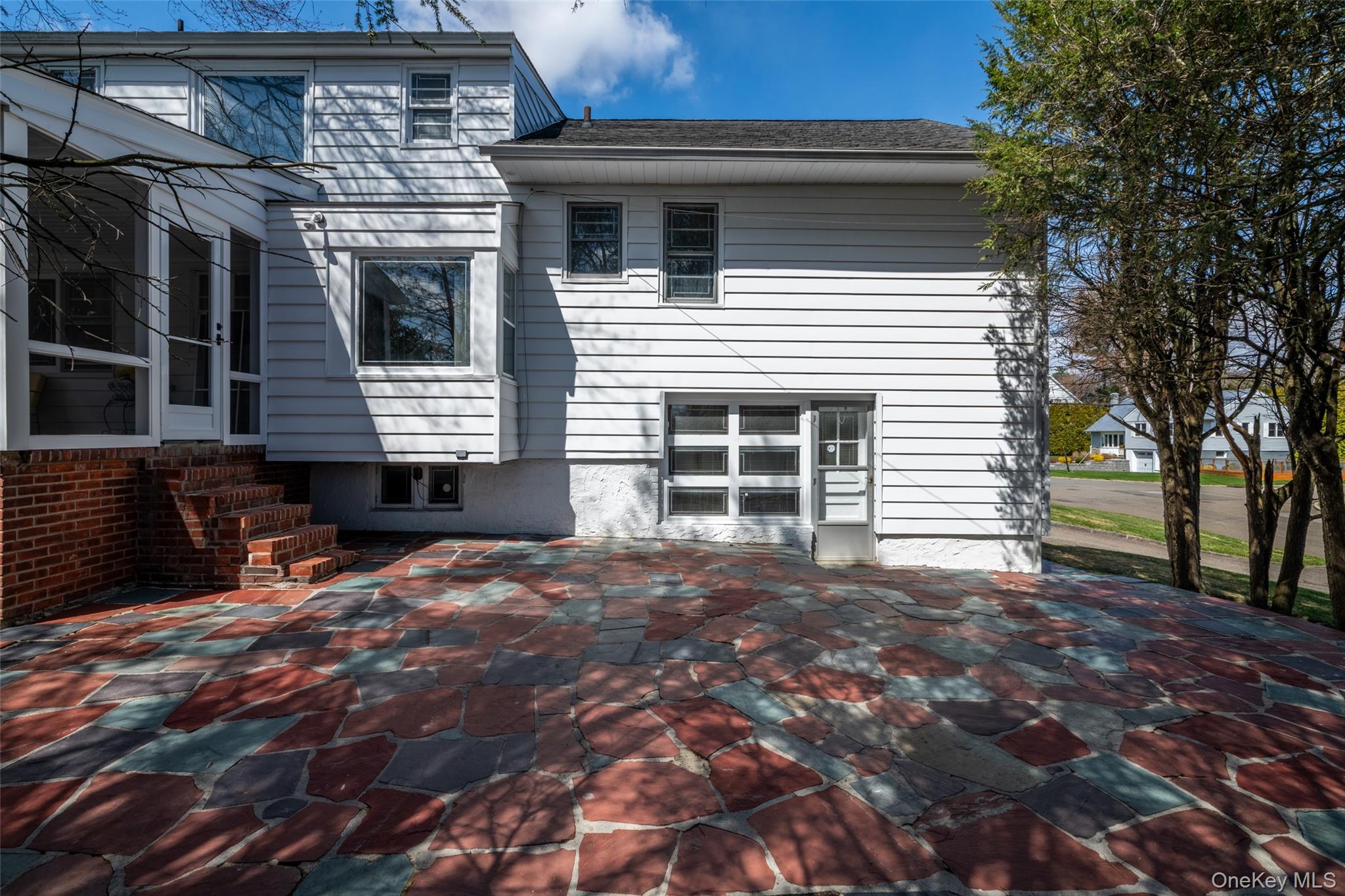 285 Stuart Drive New Rochelle, NY 10804 - Photo 24 of 37 a front view of a house with a large tree