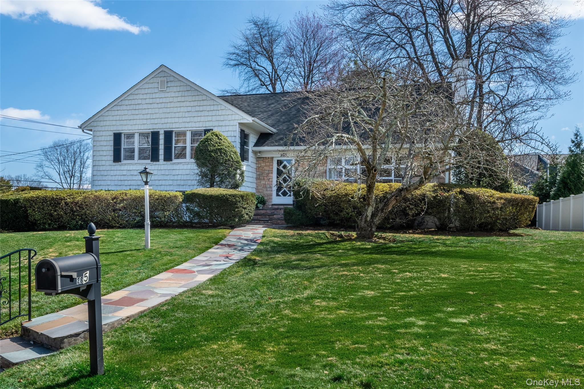 285 Stuart Drive New Rochelle, NY 10804 - Photo 35 of 37 a view of a house with a yard and a garden