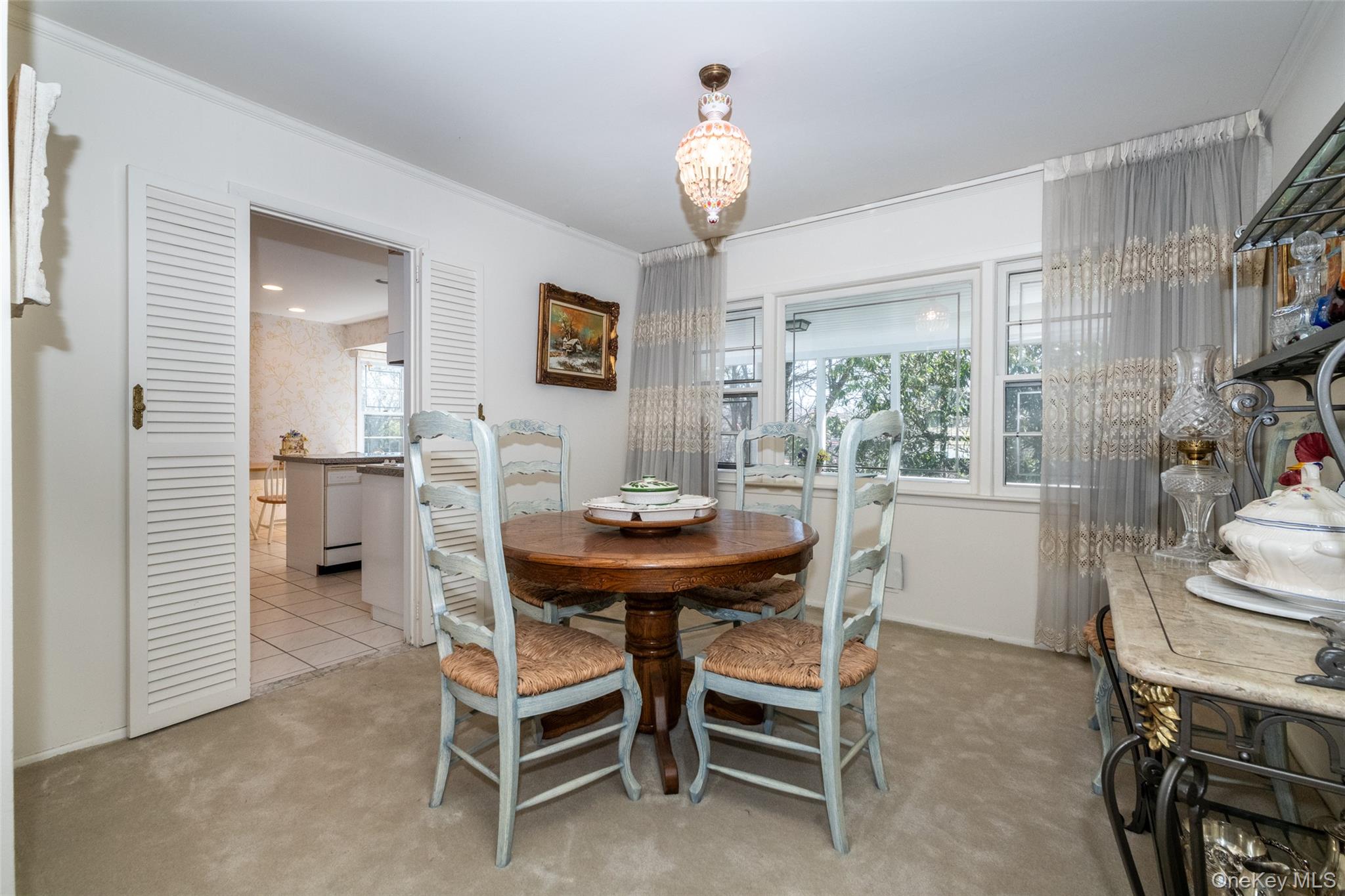 285 Stuart Drive New Rochelle, NY 10804 - Photo 7 of 37 a view of a dining room with furniture and a chandelier