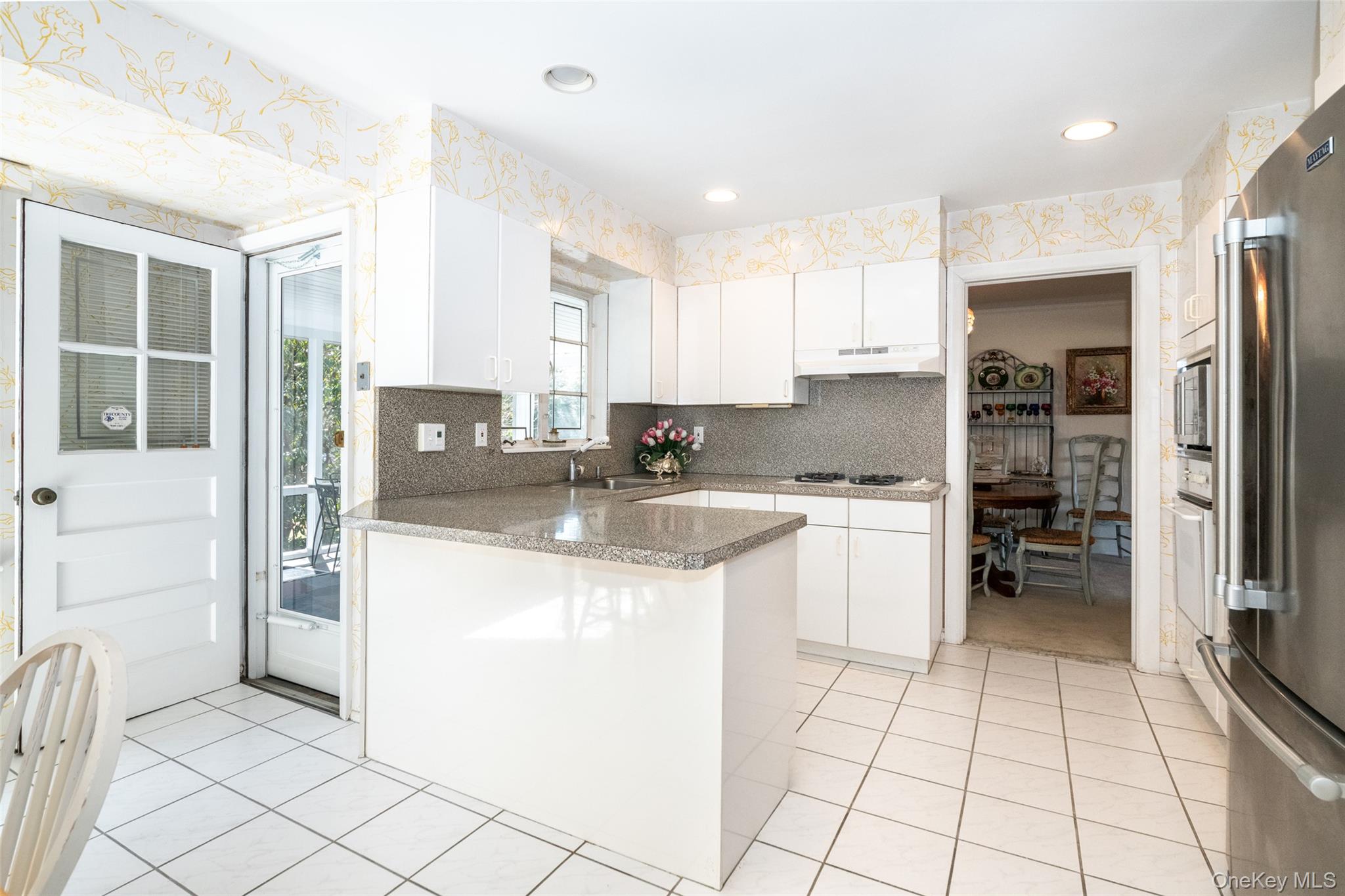 285 Stuart Drive New Rochelle, NY 10804 - Photo 9 of 37 a kitchen with stainless steel appliances granite countertop a refrigerator and a stove top oven