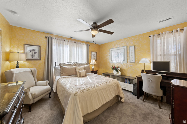 1225 North Dixie Downs Road, Unit 161 St. George, UT 84770 - Photo 12 of 21 Carpeted room featuring textured walls, a ceiling fan with integrated lighting, and multiple windows with sheer and opaque drapery