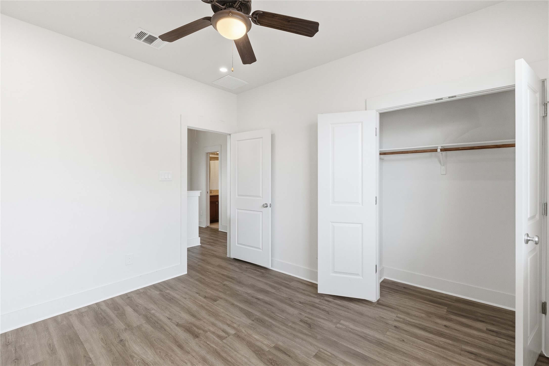 4124 Valley View Road, Unit 4A & 4B Austin, TX 78704 - Photo 18 of 40 A quiet bedroom features elegant vinyl wood flooring and a refreshing ceiling fan.
