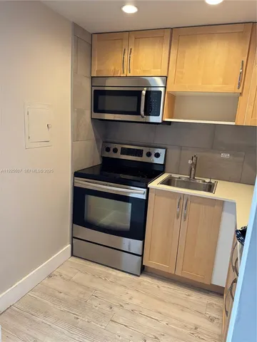 a kitchen with a stove and a microwave