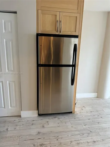 a view of a refrigerator in kitchen