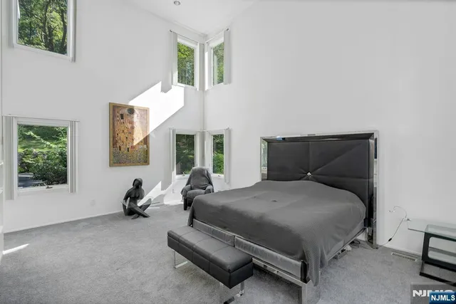 a large bed sitting in a room next to a window