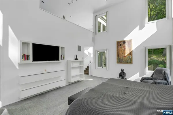 a living room with furniture white walls and a flat screen tv