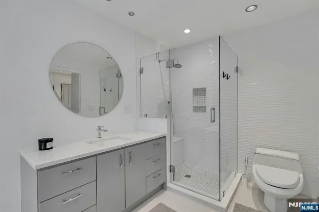 a bathroom with a toilet a sink and mirror