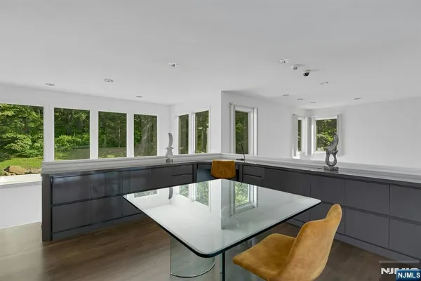 a large white kitchen with a large window