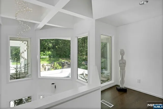 a view of an entryway with wooden floor and windows