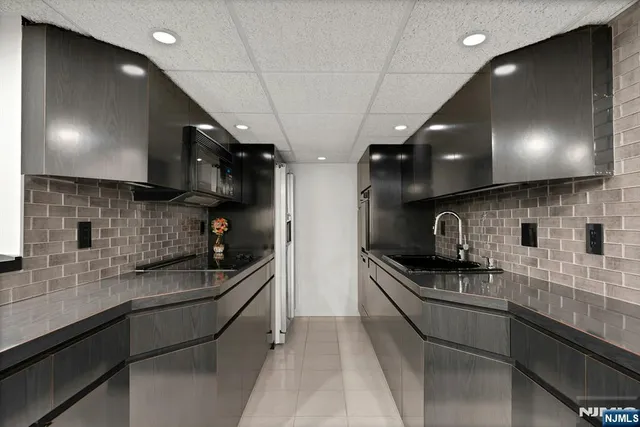 a kitchen with stainless steel appliances a sink a stove and cabinets