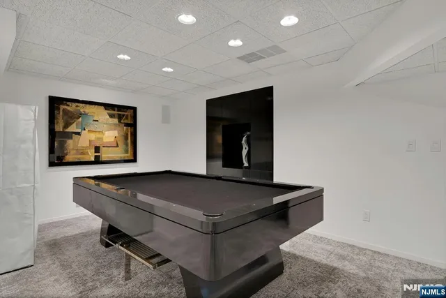 a living room with pool table